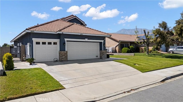 ranch-style house featuring stucco siding, a front lawn, an attached garage, a mountain view, and concrete driveway