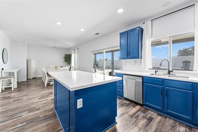 kitchen featuring a sink, stainless steel dishwasher, blue cabinetry, and dark wood finished floors