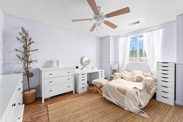 bedroom featuring visible vents, light wood-style flooring, and a ceiling fan