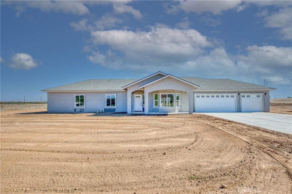 17369 Daley Rd, Madera, CA 93638 - single story home with concrete driveway, a garage, and stucco siding
