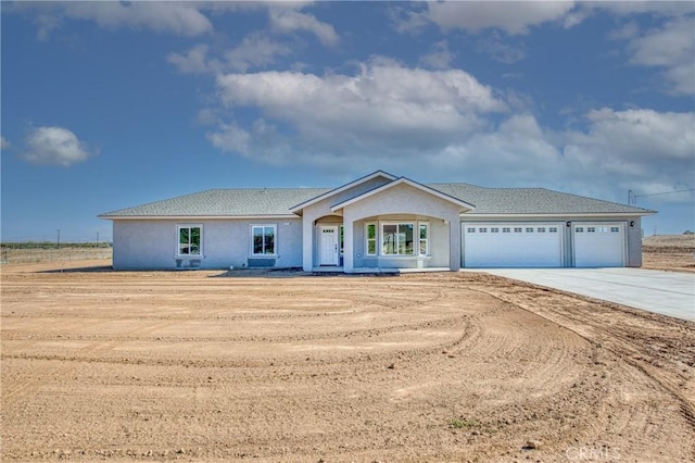 17369 Daley Rd, Madera, CA 93638 - single story home with concrete driveway, a garage, and stucco siding
