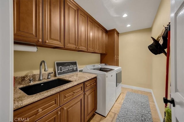 washroom featuring a sink, cabinet space, recessed lighting, washing machine and clothes dryer, and light tile patterned floors