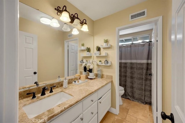 bathroom with vanity, toilet, a shower with shower curtain, and visible vents