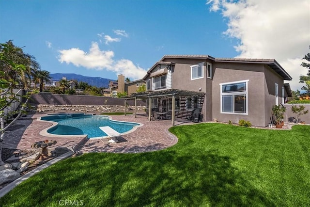 view of swimming pool featuring a diving board, a pergola, a lawn, a fenced backyard, and a patio area