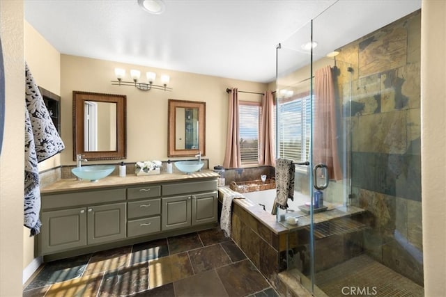 bathroom with a shower stall, a garden tub, double vanity, and a sink