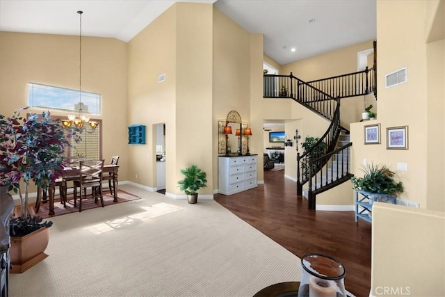 interior space featuring baseboards, visible vents, and high vaulted ceiling