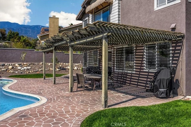 view of pool with a fenced in pool, a mountain view, a patio area, a pergola, and a fenced backyard