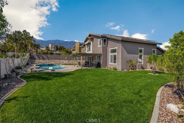 exterior space with a mountain view, a pergola, a fenced in pool, and a fenced backyard