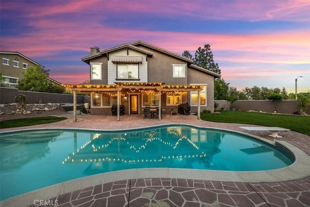 back of property at dusk featuring a pergola, a fenced backyard, a patio, and a fenced in pool