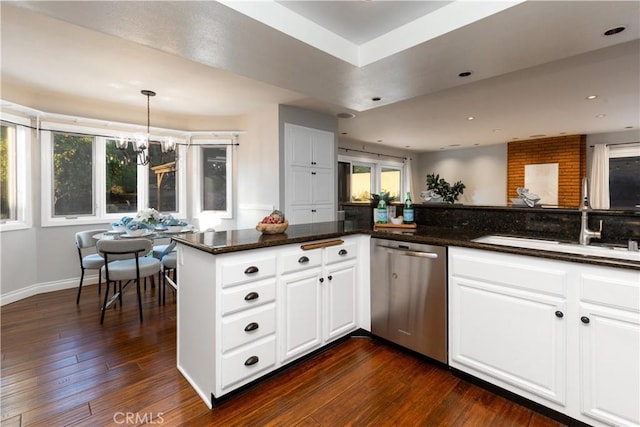 kitchen featuring a sink, stainless steel dishwasher, white cabinets, and dark wood-style flooring
