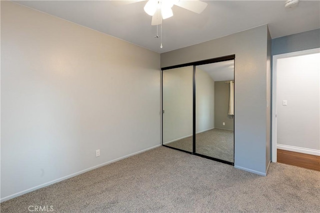 unfurnished bedroom with a closet, ceiling fan, baseboards, and carpet