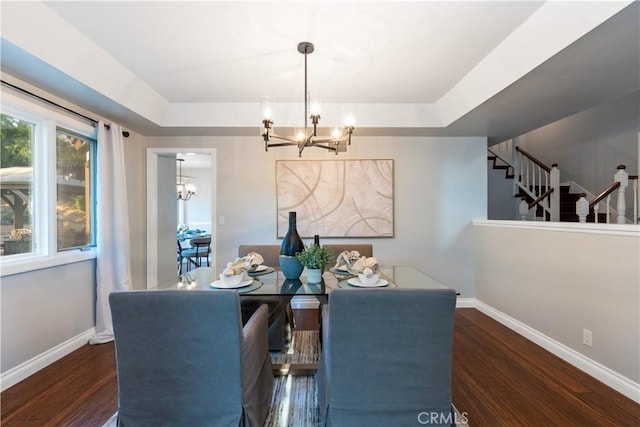 dining area with a notable chandelier, baseboards, and wood finished floors