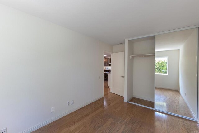 6462 Camino Del Parque, Carlsbad, CA 92011 - unfurnished bedroom featuring wood finished floors and a closet