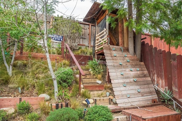 view of playground with stairway and fence