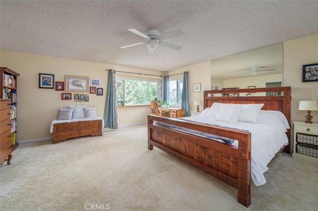 bedroom with carpet floors, a textured ceiling, and baseboards