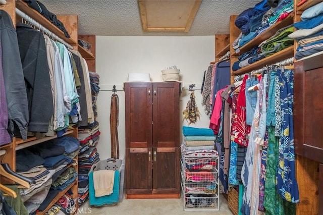 walk in closet featuring attic access