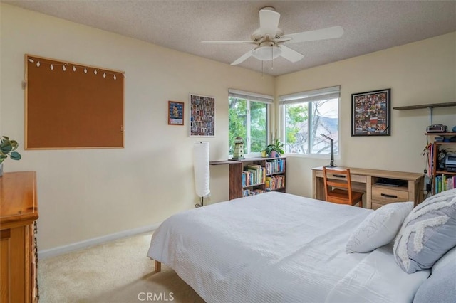 carpeted bedroom featuring a ceiling fan and baseboards