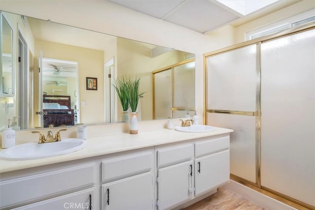 full bathroom with ensuite bath, a sink, double vanity, and a stall shower