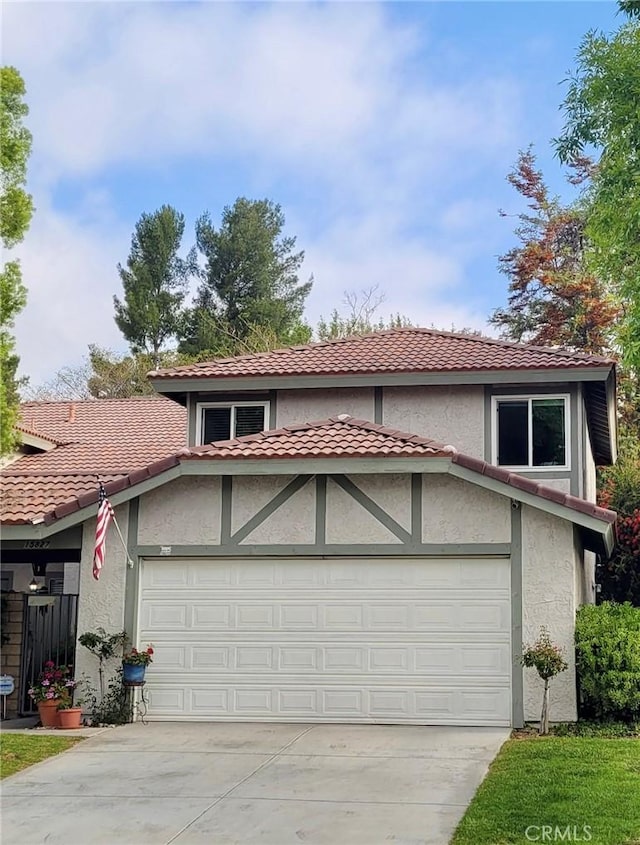 view of front of house featuring a garage, driveway, and stucco siding