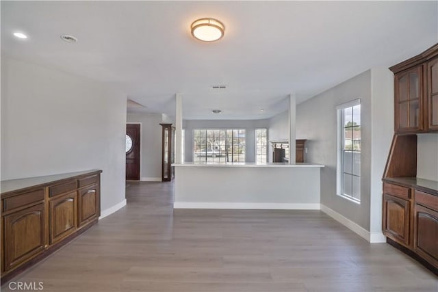 kitchen with recessed lighting, open floor plan, light wood-type flooring, and baseboards