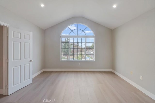 unfurnished room with recessed lighting, light wood-style flooring, baseboards, and vaulted ceiling