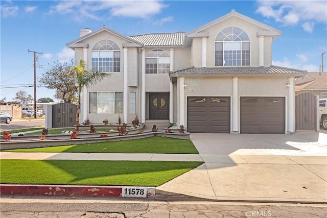 view of front of home featuring a garage, a chimney, a tile roof, stucco siding, and driveway