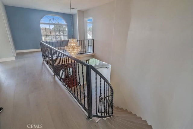 stairway with a chandelier and baseboards