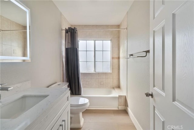bathroom with shower / tub combo, vanity, baseboards, toilet, and wood finished floors