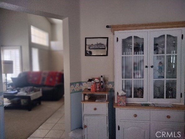6353 Colonial Ave, Banning, CA 92220 - kitchen with light tile patterned flooring and white cabinetry