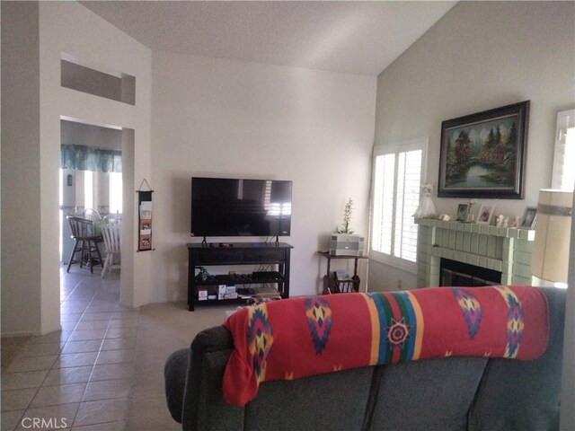 6353 Colonial Ave, Banning, CA 92220 - living room featuring tile patterned flooring, a brick fireplace, and lofted ceiling