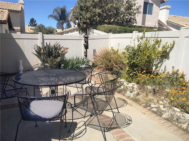 view of patio featuring a fenced backyard and outdoor dining space