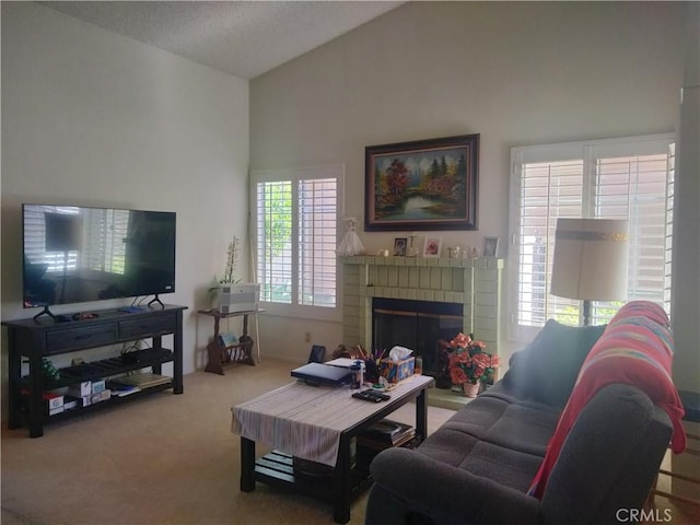 carpeted living room featuring vaulted ceiling and a fireplace