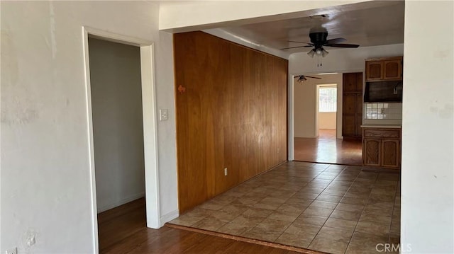 432 Oakford Dr, Los Angeles, CA 90022 - spare room featuring a ceiling fan, wood walls, and baseboards