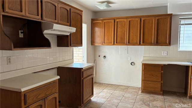 432 Oakford Dr, Los Angeles, CA 90022 - kitchen featuring backsplash, under cabinet range hood, brown cabinetry, and light countertops
