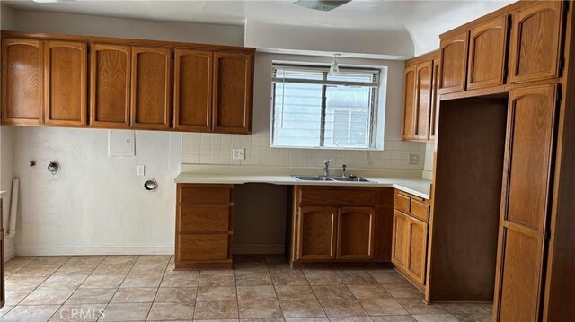 432 Oakford Dr, Los Angeles, CA 90022 - kitchen featuring brown cabinets, light countertops, and tasteful backsplash
