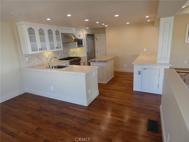 304 27th St, Manhattan Beach, CA 90266 - kitchen featuring a sink, a peninsula, appliances with stainless steel finishes, a center island, and decorative backsplash