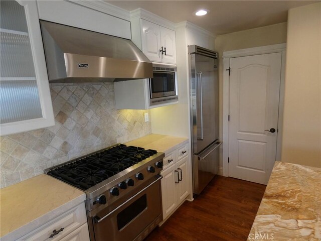 304 27th St, Manhattan Beach, CA 90266 - kitchen with high end appliances, wall chimney range hood, dark wood finished floors, light countertops, and white cabinetry