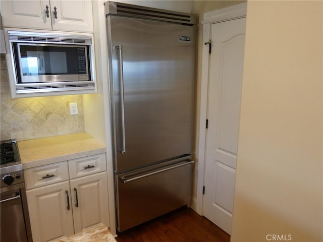 304 27th St, Manhattan Beach, CA 90266 - kitchen with built in appliances, backsplash, light countertops, and white cabinetry