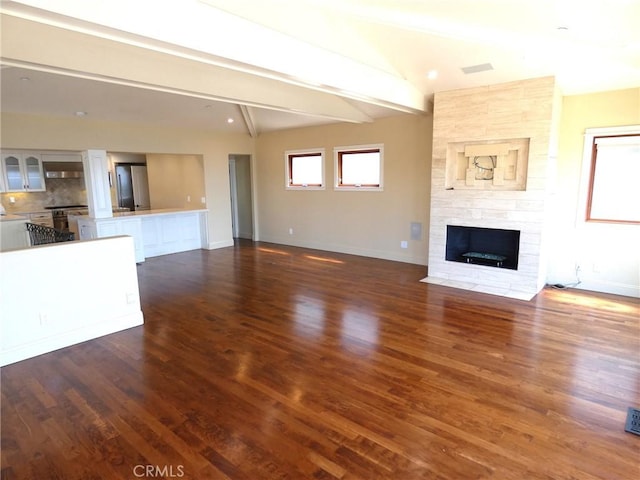 304 27th St, Manhattan Beach, CA 90266 - unfurnished living room featuring beamed ceiling, baseboards, dark wood-style flooring, and a fireplace