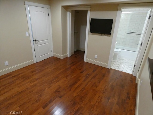 304 27th St, Manhattan Beach, CA 90266 - unfurnished bedroom featuring baseboards, wood finished floors, connected bathroom, a spacious closet, and a closet