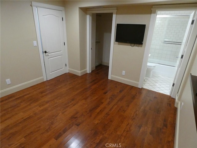 304 27th St, Manhattan Beach, CA 90266 - unfurnished bedroom featuring wood finished floors, ensuite bathroom, a spacious closet, and a closet