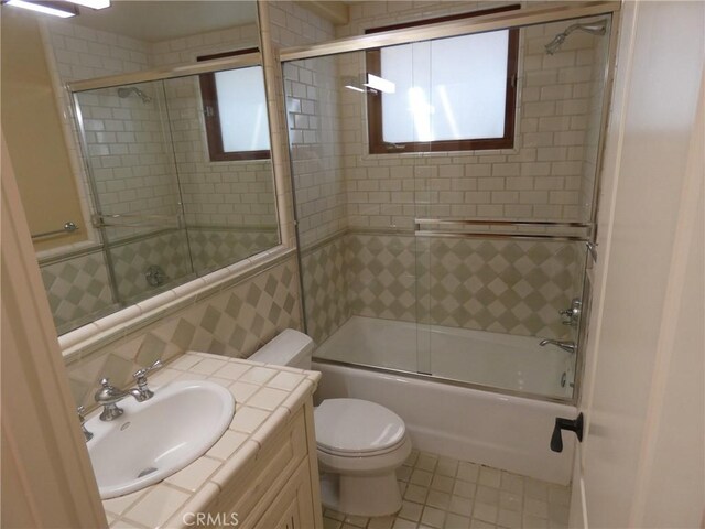 304 27th St, Manhattan Beach, CA 90266 - bathroom featuring toilet, bath / shower combo with glass door, vanity, and tile patterned floors