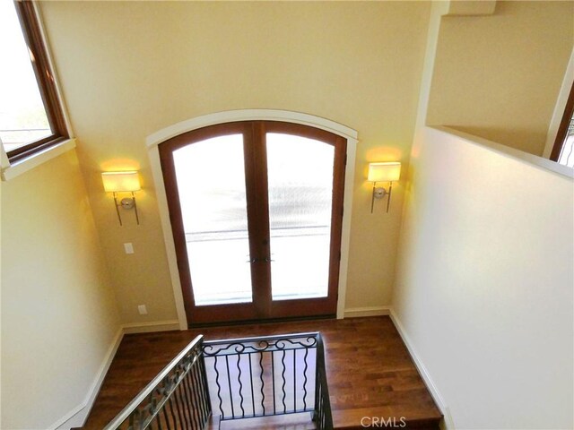 304 27th St, Manhattan Beach, CA 90266 - doorway with arched walkways, wood finished floors, french doors, and baseboards