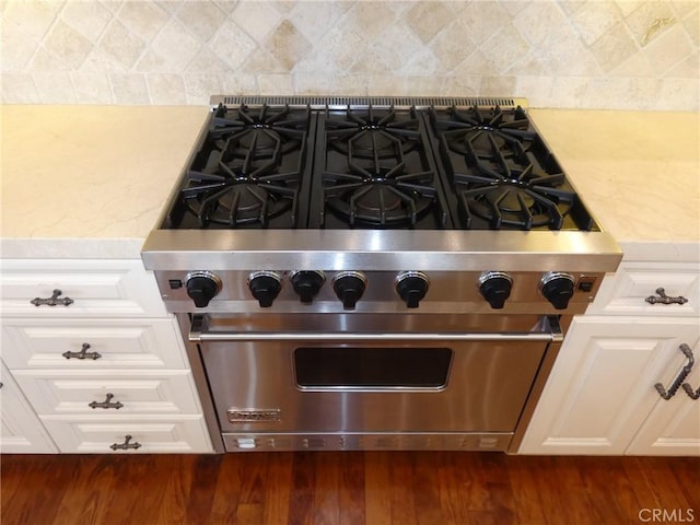 304 27th St, Manhattan Beach, CA 90266 - kitchen view of luxury stove, backsplash, dark wood finished floors, and white cabinets