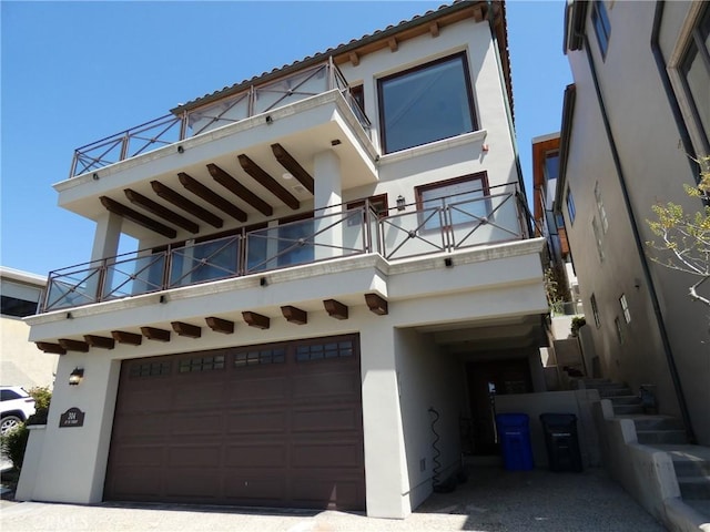 304 27th St, Manhattan Beach, CA 90266 - view of front of property featuring a balcony, stucco siding, and an attached garage