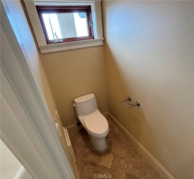 304 27th St, Manhattan Beach, CA 90266 - bathroom with toilet, baseboards, and stone finish floors