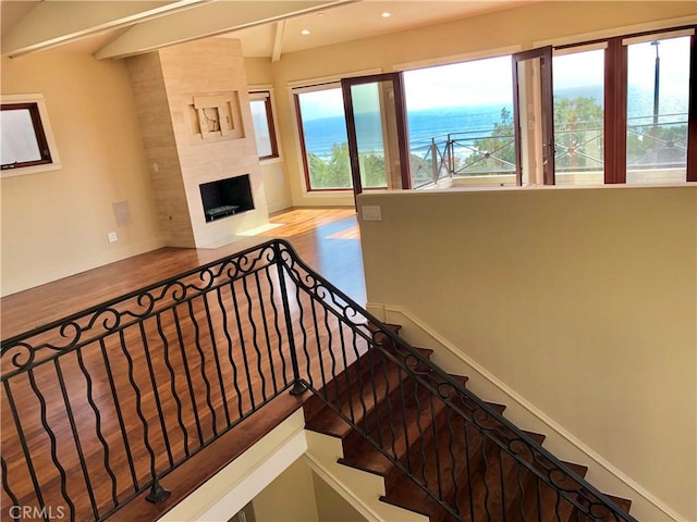 304 27th St, Manhattan Beach, CA 90266 - staircase with baseboards, recessed lighting, wood finished floors, a water view, and a tiled fireplace