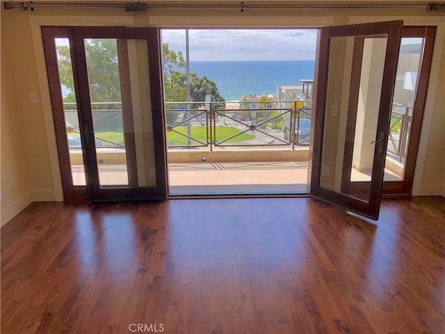 304 27th St, Manhattan Beach, CA 90266 - doorway with wood finished floors, baseboards, and a water view