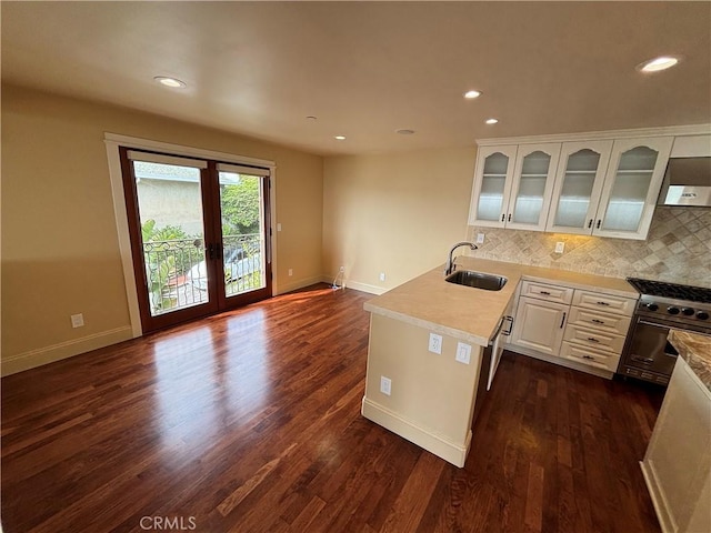 304 27th St, Manhattan Beach, CA 90266 - kitchen with stainless steel stove, a peninsula, glass insert cabinets, white cabinets, and backsplash