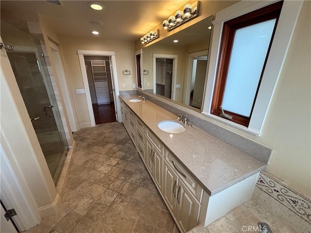 304 27th St, Manhattan Beach, CA 90266 - full bathroom featuring a shower stall, double vanity, a walk in closet, stone finish flooring, and recessed lighting